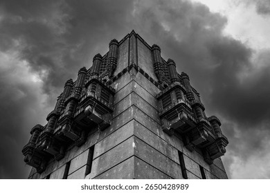 Dramatic low angle view of brutalist architecture under stormy sky