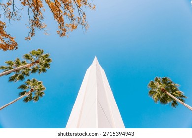 Dramatic Low Angle View of a Modern White Pointed Monument Reaching into a Clear Blue Sky
