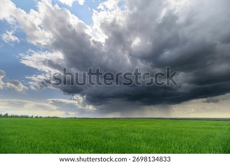 Dramatic and Majestic Clouds Hovering Over Beautiful Lush Green Fields and Landscapes