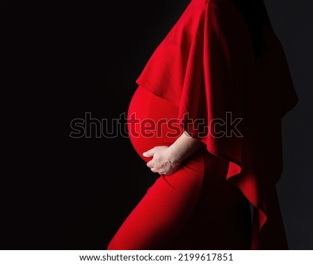 Dramatic maternity profile of a pregnant woman's belly from the side in 3rd trimester Stock photo © 