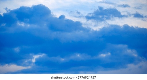 Dramatic meteorological scenery capturing heavy dark blue and grey cloud masses gathering ominously over an unseen vast distant horizon.