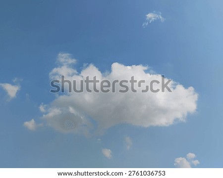 Dramatic mild cumulative clouds floats in the sunny daylight