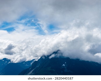 Dramatic mist and layered clouds engulf mountain peaks near Hope, British Columbia, Canada, evoking calm and awe.
