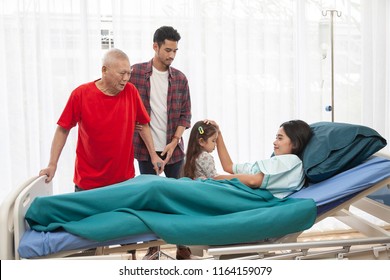 dramatic Moment of family visit to patient or sick asian woman in room at Hospital. Visit of visitors to the patient to the hospital and Medicine and health care Concept. 