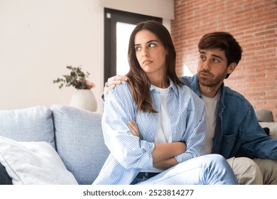 A dramatic moment of relationship breakdown between a young couple, as the offended girlfriend ignores her partner's emotional attempts to explain himself. Themes of infidelity