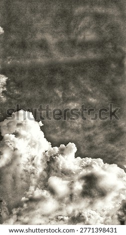 Dramatic monochrome cumulus clouds against a dark, textured sky. This moody, vintage-style atmosphere features high contrast and grainy artistic details, perfect for dramatic backgrounds and fine art.