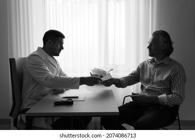 Dramatic Monochrome Image Of Doctor Diagnostic Patient's Terminal Illness