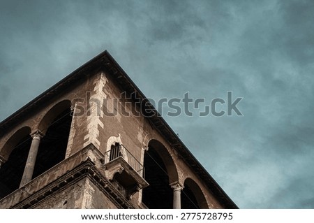 Dramatic Moody Ancient Stone Building Corner with Stormy Sky and Copy Space Background