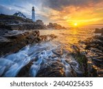 A dramatic morning at the Cape Elizabeth lighthouse located in the Fort Williams Park on Casco Bay . Portland Head Light was constructed in 1791. It is the state