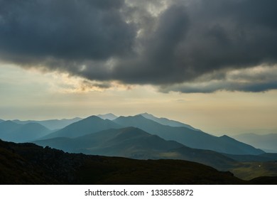 Dramatic mountain landscape with cloudy sky at sunset