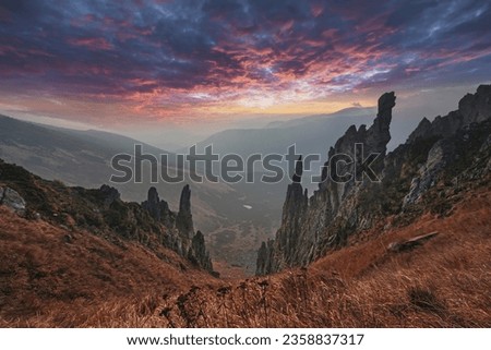 Dramatic mountain landscape. Sharp needle rocks and vibrant sunset sky high in the mountains.