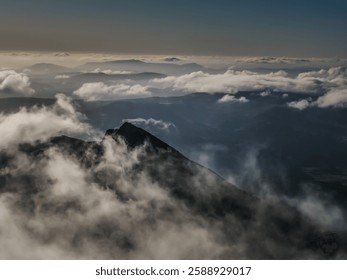Dramatic Mountain Peak Emerging from the Clouds – Aerial Landscape Photography