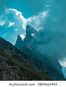 Dramatic mountain peak emerging through clouds in the Dolomites, Italy