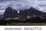 Dramatic Mountain Peaks Under Cloudy Sky In A Serene Natural Landscape