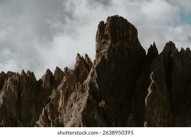Dramatic mountain peaks under a cloudy sky in a stunning natural landscape.