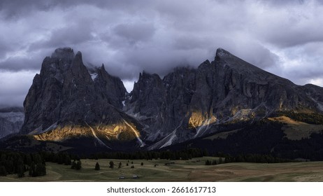 Dramatic Mountain Peaks Under Cloudy Sky In A Serene Natural Landscape