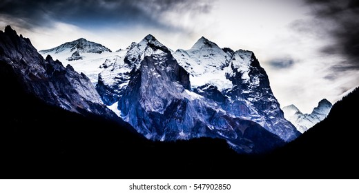 Dramatic Mountain Range With Stormy Clouds In The Sky - Color