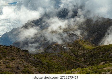 Dramatic Mountain Ridges Covered By Clouds And Mist