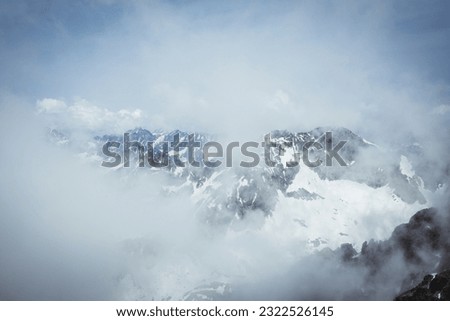 Dramatic mountain scenery in the High Tatras mountains Slovakia, with snow-capped summits and swirling clouds. Taken from the summit of Lomnický štít. [[stock_photo]] © 