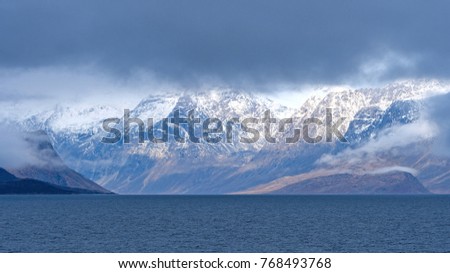 Dramatic Mountains Breaking Through the Coastal Clouds in Auyuittiq National Park on Baffin Island near Pangnirtung, Nunavut, Canada