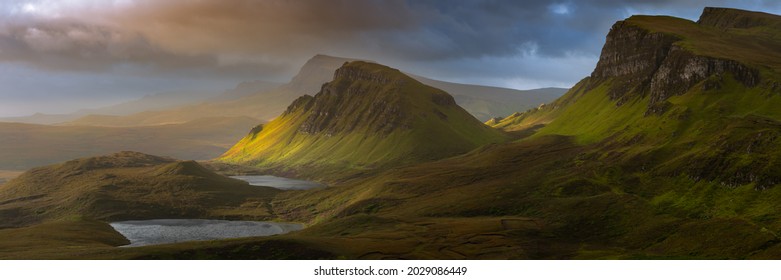 Dramatic mountains of the Isle of Skye seen from viewpoint on the Quiraing. Large panorama with dark moody clouds. Scotland landscapes, UK.