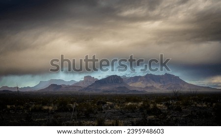 Dramatic Mountains Just Up from the Valley under Thick Clouds