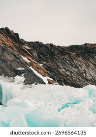 dramatic natural scene highlighting dynamic between warm rock formations and icy landscapes