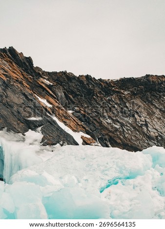 dramatic natural scene highlighting dynamic between warm rock formations and icy landscapes