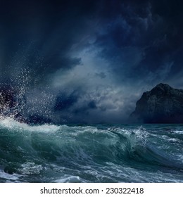 Dramatic nature background - big wave and dark rock in stormy sea, stormy weather
