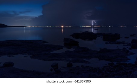 Dramatic nature background - thunders in dark sky over the sea