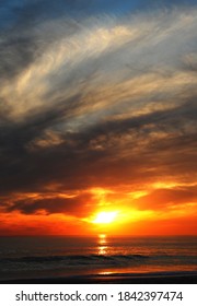 Dramatic ocean sunset with cloud cover