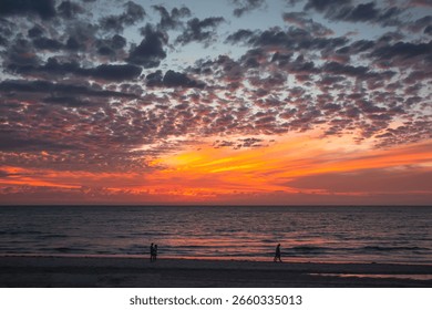 Dramatic ocean sunset with golden rays and glowing clouds, Australia
