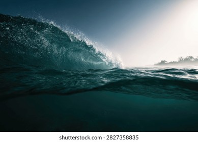 A dramatic ocean wave barrels forward, its translucent face catching the bright sunlight, creating a mesmerizing display of water and light.