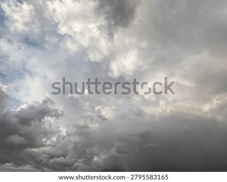 Dramatic Oncoming Turbulent Storm Clouds With Scattered Blue Sky In the Background