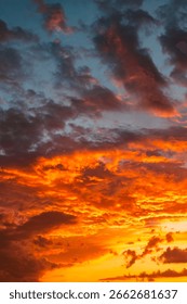 Dramatic orange sky. Sunset sky vertical background photo. Dramatic clouds at sunset.