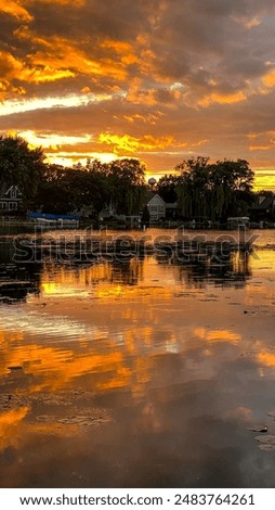 Dramatic Orange Sunset over Yarhara River Channel with Water Reflections