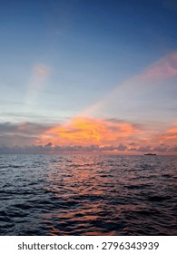 Dramatic Orange Sunset Sky Over Calm Sea Landscape

Vibrant fiery orange clouds on a deep blue sky during sunset over dark ocean water ripples, ideal for background, travel, and nature projects.
