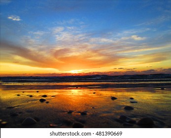 Dramatic orange and yellow sunset over the sea.