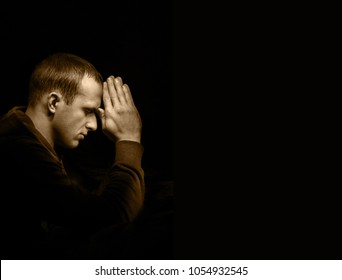 Dramatic orthodox evangelical baptist pious lonely stress mourn young white guy kneeling for ask implore wish upwards Jesus Christ. Modern think concept copyspace with space for text on dark backdrop
