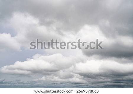 Dramatic overcast sky with gray and white clouds before rainy season storm, moody and gloomy weather background. Climate, meteorology, and atmospheric. Weather forecasting, climate change background.