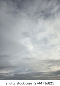 Dramatic overcast sky with soft grey and white clouds. Natural abstract weather background texture.