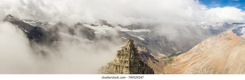 Dramatic panorama with clouds and mountains.