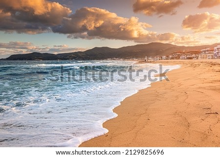 Dramatic panoramic view of iconic Sarti resort town and famous long and empty sandy beach at sunset time. Vacation on Halkidiki, Greece