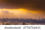 A dramatic panoramic view of Kuala Lumpur city skyline in Malaysia under dark storm clouds with glowing sunset light, captured from Bukit Ampang. Moody urban landscape with skyscraper silhouettes and atmospheric weather.
