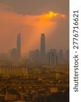 A dramatic panoramic view of Kuala Lumpur city skyline in Malaysia under dark storm clouds with glowing sunset light, captured from Bukit Ampang. Moody urban landscape with skyscraper silhouettes and atmospheric weather.