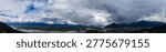 Dramatic panoramic view of river channels, farmland and storm clouds over Harrison Mills in Fraser Valley, British Columbia, Canada