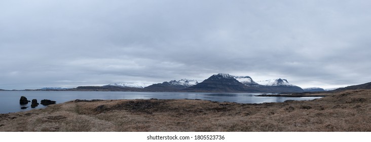 A dramatic panoramic view to snowy mountains range over Berufjordur fjord near Djupivogur town in eastern Iceland.
A panoramic view to Berufjordur fjord, snowy mountains range, cloudy and vast sky.