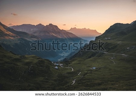 Dramatic panoramic view of Swiss Alps with road and valley at Klausen Pass, Uri Canton, Switzerland