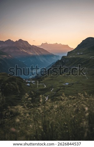 Dramatic panoramic view of Swiss Alps with road and valley at Klausen Pass, Uri Canton, Switzerland