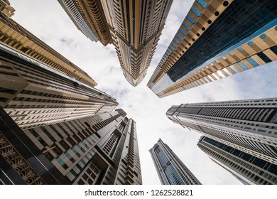 Dramatic perspective with low angle view of skyscrapers looking up to the sky, Dubai. Vanishing point